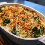 Overhead shot of a baked Broccoli Cheese Casserole in a white baking dish.