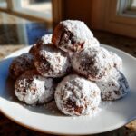 Pile of Chocolate Peppermint Snowball Cookies dusted with powdered sugar, ready to eat.