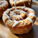Close-up of a delicious Cinnamon Roll Sugar Cookie Cup with icing drizzled on top.