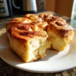 Close-up of fluffy Cloud Bread Cinnamon Rolls on a white plate, showing the soft interior.