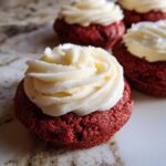 Close-up of Easy Crumbl Red Velvet Cupcake Cookies with white frosting.