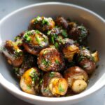 Close-up of a bowl of Garlic Butter Mushrooms, garnished with fresh parsley.