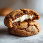 Close-up of a Gingerbread Cheesecake Stuffed Cookie, showing the creamy cheesecake filling.