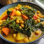 Close-up of a bowl of Immune-Boosting Turmeric Veggie Soup with chickpeas, carrots, and kale.