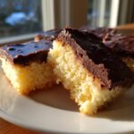 Close-up of North Pole Chocolate-Dipped Shortbread Bars on a plate, showing the shortbread and chocolate.