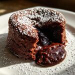 Close-up of a 4-Ingredient Nutella Lava Cake with molten chocolate center and powdered sugar.