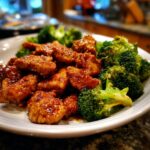 Close-up of One-Pan Honey Soy Chicken and Broccoli on a white plate, a flavorful and easy meal.