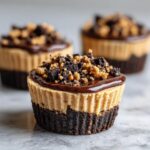 Close-up of Peanut Butter Oreo Fudge Cups with chocolate and cookie crumble topping.