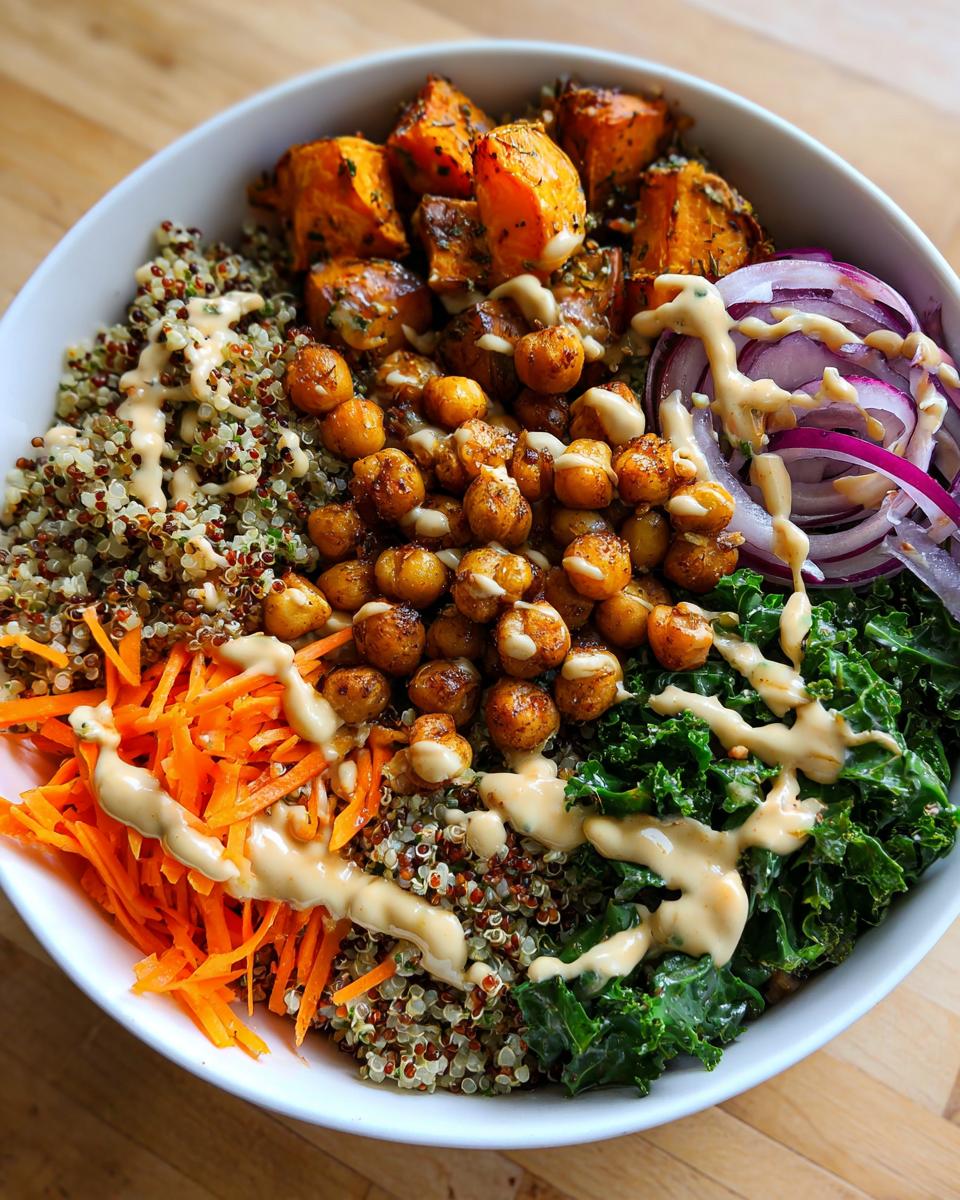 Overhead shot of a delicious Spiced Chickpea and Sweet Potato Buddha Bowl with quinoa, kale, and carrots.