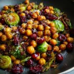 Close-up of Spicy Roasted Chickpeas Brussels Sprout Salad with cranberries and parmesan.