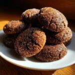 A pile of Starbucks Copycat Ginger Molasses Cookies, coated in sparkling sugar, on a white plate.