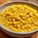 Close-up of a bowl filled with creamy Sweet Corn Chowder, showing the texture and color.
