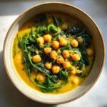 Overhead shot of Vegan Chickpea & Spinach Soup in a bowl, with chickpeas and spinach.