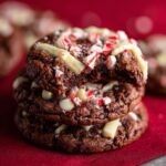 Close-up of a stack of White Chocolate Peppermint Crunch Cookies with white chocolate and crushed peppermint.