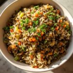 Overhead shot of a bowl of Wild Rice Pilaf with carrots, celery, and parsley.