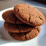 A stack of four fresh, homemade Best Chocolate Sugar Cookies on a white plate.