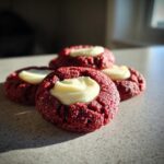 Close-up of Red Velvet Cream Cheese Thumbprint Cookies, delightful treats.