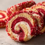 Close-up of sliced Swirl Cookies, red and white pinwheel design, covered in sprinkles for Valentine's Day.