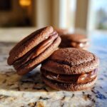 Close-up of two Valentine's ganache cookies with rich chocolate ganache filling.